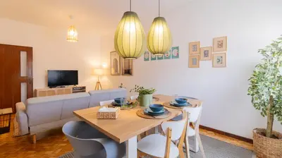 a living room with a table and a couch at Bright apartment next metro in Porto