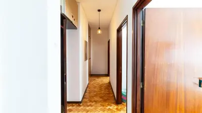 a hallway with a door and a room with a floor at Bright apartment next metro in Porto