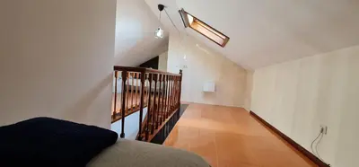 a room with a stairway with a skylight at Flores duplex in Porto