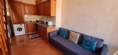 a living room with a blue couch in a kitchen at Flores duplex in Porto