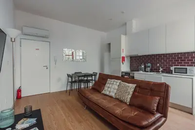 a room with white walls and a hallway with closets at Mira Alfandega apartment in Porto