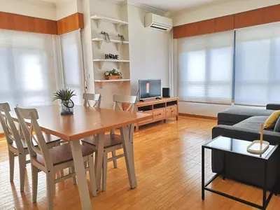 a living room with a dining room table and a couch at Palácio Garden's House by LovelyStay in Porto