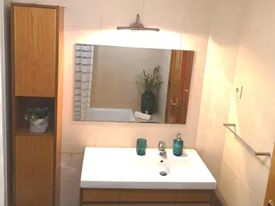 a bathroom with a white sink and a mirror at Palácio Garden's House by LovelyStay in Porto