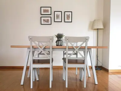 a dining room table with two chairs and a lamp at Palácio Garden's House by LovelyStay in Porto