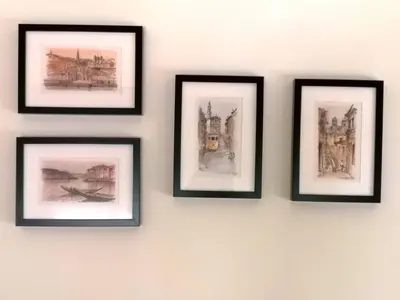 four framed drawings of buildings on a wall at Palácio Garden's House by LovelyStay in Porto