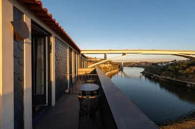 a balcony with a table and a view of a river at GuestReady - An urban retreat with river view in Porto