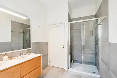 a bathroom with a shower and a sink at VIVA Boavista Vintage House in Porto