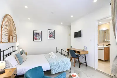 a bedroom with a bed and a desk and a table at Casa Maya in Porto