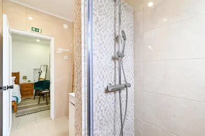 a bathroom with a shower with a glass door at Casa Maya in Porto