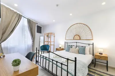 a bedroom with a bed and a desk and a window at Casa Maya in Porto