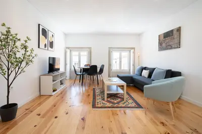 a living room with a couch and a table at Host Wise - Modern Urban Flat in Porto