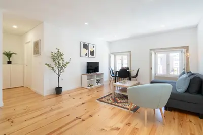 a living room with a couch and a table at Host Wise - Modern Urban Flat in Porto