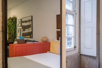 a bedroom with a red cabinet and a window at Green Hideaway by LovelyStay in Porto