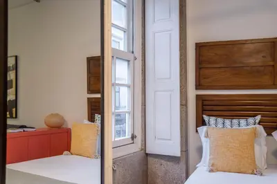 a bedroom with two beds and a window at Green Hideaway by LovelyStay in Porto