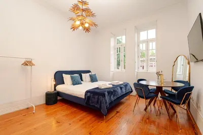 a bedroom with a bed and a table and chairs at Casa D'Almeida by Porto Stories in Porto