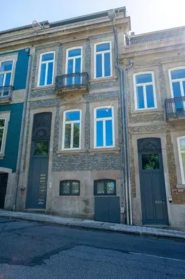 a large brick building with blue doors and windows at HM - Oporto Studio Pool Oasis in Porto