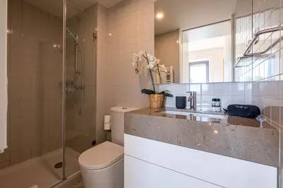 a bathroom with a sink and a toilet and a shower at HM - Oporto Studio Pool Oasis in Porto