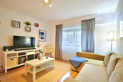 a living room with a couch and a tv at Lips Friendship Shelter in Porto