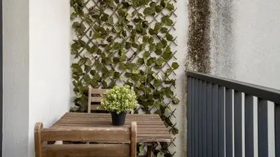 a wooden table with a plant on a wall at Serene 1BR Spot by LovelyStay in Porto