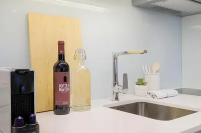 a bottle of wine sitting on a counter next to a sink at Unique Antas Park in Porto