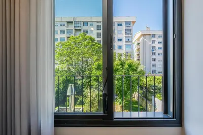a window with a view of a building at GuestReady - Lovely city retreat in Boavista in Porto