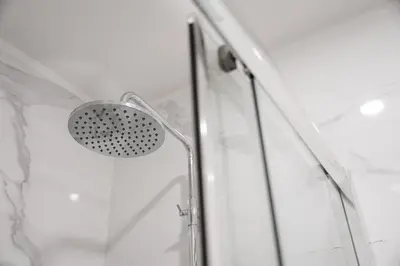 a shower with a shower head in a bathroom at GuestReady - Lovely city retreat in Boavista in Porto