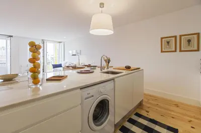 a kitchen with a sink and a washing machine at Merc Porto Vitoria's Place in Porto