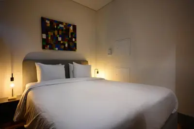 a bedroom with a large white bed with two pillows at Live In Porto - Codeçal in Porto
