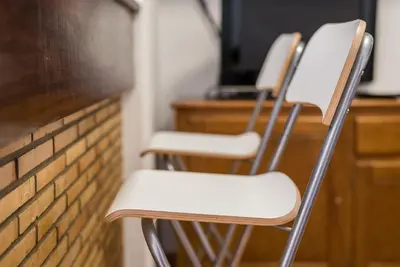 three white chairs sitting in front of a desk at GuestReady - Urban escape with a view in Porto