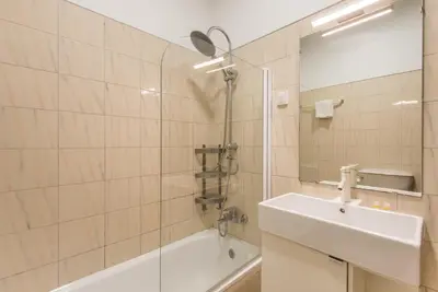 a bathroom with a sink and a tub and a mirror at GuestReady - Urban escape with a view in Porto