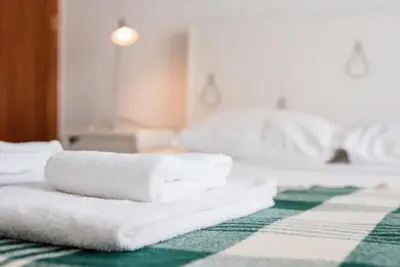 a pile of towels sitting on top of a bed at GuestReady - Urban escape with a view in Porto