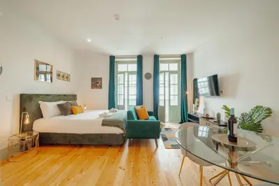 a bedroom with a bed and a glass table at Downtown Suites by Vacationy in Porto