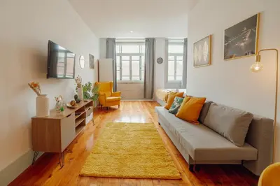 a living room with a couch and a table at Downtown Suites by Vacationy in Porto