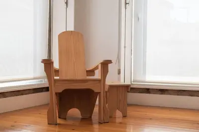 a wooden chair sitting in front of a window at Casa B in Porto