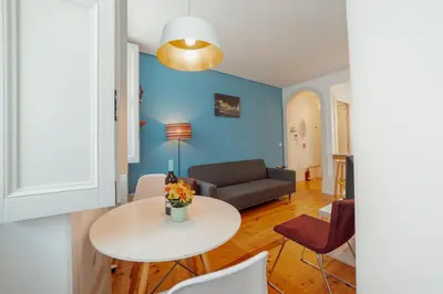 a living room with a table and a couch at Downtown Charming by Vacationy in Porto