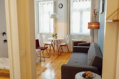 a living room with a couch and a table at Downtown Charming by Vacationy in Porto