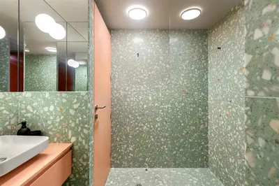 a bathroom with a shower with a sink and a mirror at Pelicano in Porto