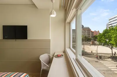 a room with a window with a view of a street at Pelicano in Porto