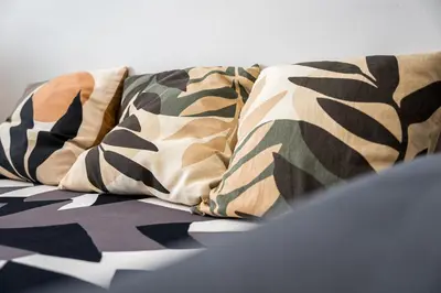 a couple of pillows sitting on top of a bed at Refugio no oPorto in Porto
