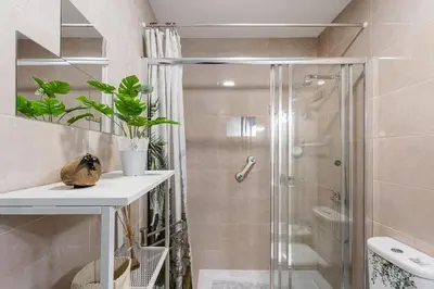 a bathroom with a shower with a glass door at Refugio no oPorto in Porto
