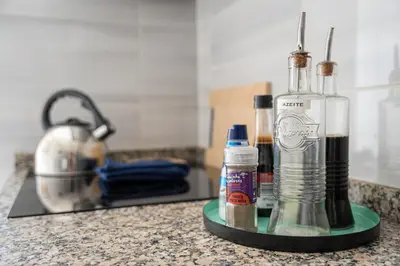 a bottle of alcohol sitting on a counter next to a stove at Refugio no oPorto in Porto