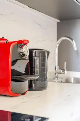 a toaster sitting on a kitchen counter next to a sink at Modern Downtown Studio in Porto