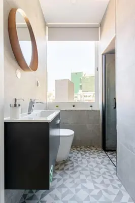 a bathroom with a toilet and a sink and a mirror at Modern Downtown Studio in Porto