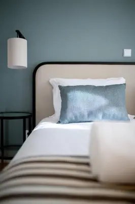 a bedroom with a white bed with a blue wall at VC Heritage Ribeira Porto in Porto
