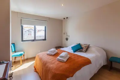 a bedroom with a bed with two towels on it at Picaria - Riders Lodge in Porto