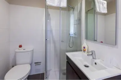 a bathroom with a shower and a toilet and a sink at Picaria - Riders Lodge in Porto