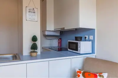 a kitchen with a microwave on a blue counter top at Picaria - Riders Lodge in Porto