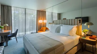 a hotel room with a large bed and a desk at Altis Porto Hotel, a member of Preferred Hotels & Resorts- LVX in Porto