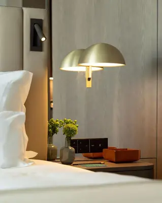 a bedroom with a bed and a lamp on a table at Altis Porto Hotel, a member of Preferred Hotels & Resorts- LVX in Porto