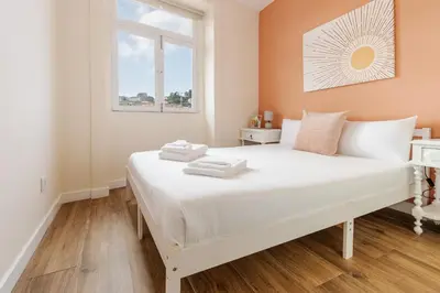 a white bed in a room with a window at Porto Riverville Apartments in Porto